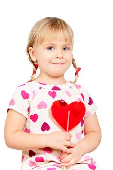 Cute little girl holding big red heart shaped lolly pop candy