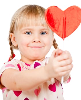 Cute little girl showing big red heart shaped lolly pop candy