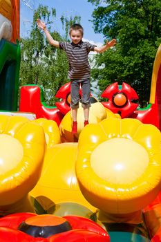 Young boy jumping on inflatable playground