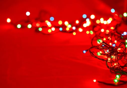 Christmas lights on red background, shallow focus