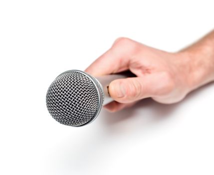 Hand holding microphone on white background