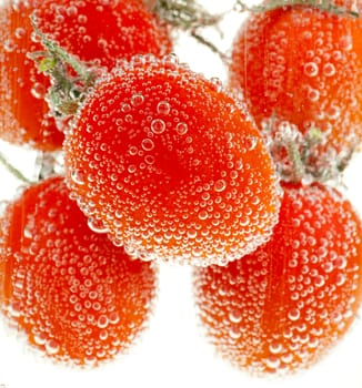 Cherry tomatoes in water with bubbles