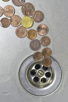 small Euro coins are cast-off and go to drain