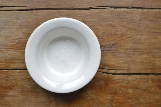white ceramic bowl on the vintage wooden table