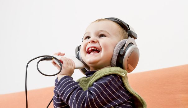 young child on couch with big earphone