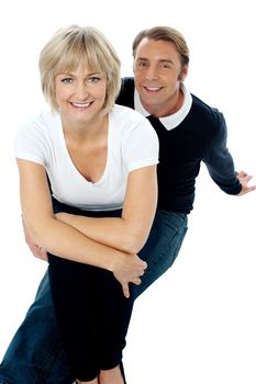 Beautiful lady sitting on his man's lap. Indoor studio shot