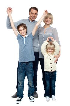 Playful kids with parents over white background, raising hands.