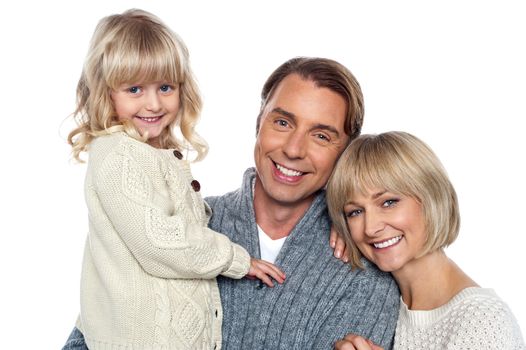 Cheerful family of three posing for camera. Father, mother and daughter.