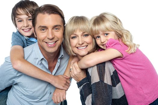 Happy family of four members posing together isolated on white background