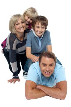 Fun loving family exhibiting great bonding. Indoor studio shot.