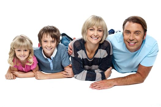 Smiling family of four relaxing on white background. Display of love and affection.