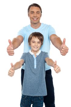 Handsome father and son showing thumbs up gesture to the camera. Capture the moment.