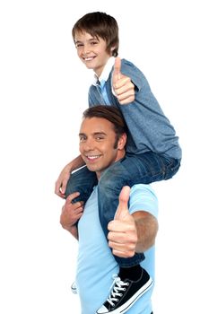 Confident father carrying his son on shoulder. Both gesturing thumbs up to camera.