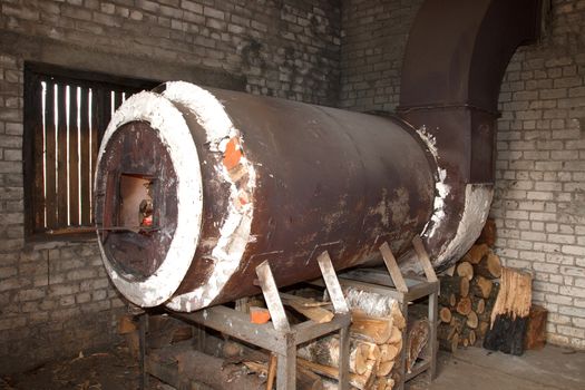 old rusty metal industrial oven heated with wood