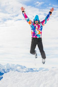 Young man a ski outfit jumping in snow at winter outdoor in the Zillertal Arena, Austria