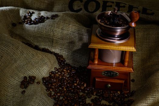 Coffee Mill with beans and burlap. still life