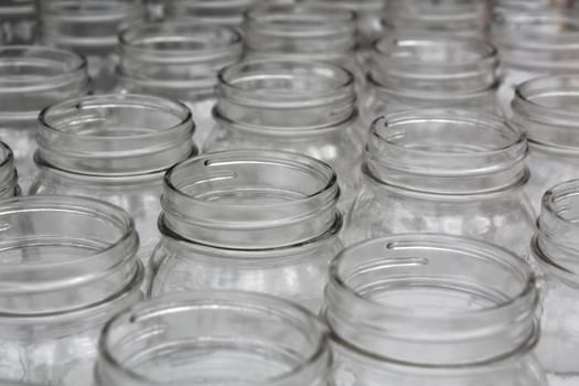 Closeup details on a lot of Empty Glass Jars