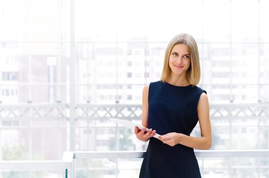 business woman holding reports and looking to the camera, copy space