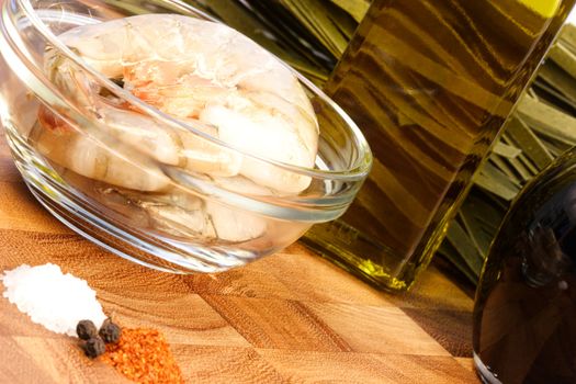 raw fresh prawns with other food ingredients on fancy cutting board