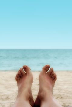 Sandy Woman Feet on a Tropical Beach