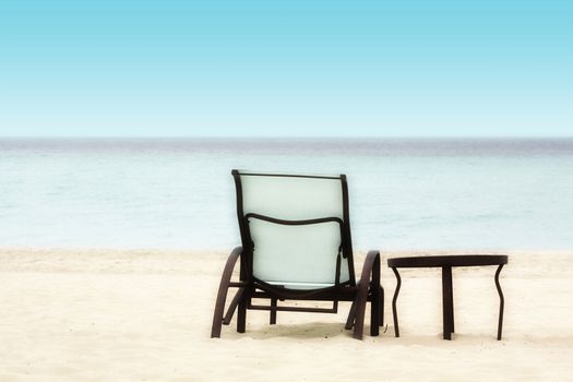 Empty Chair and Table on a Tropical Beach