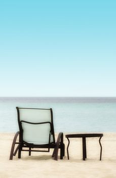 Empty Chair and Table on a Tropical Beach