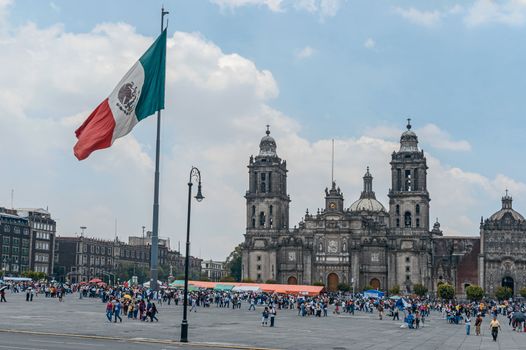 The Metropolitan Cathedral of the Assumption of Mary of Mexico City is the oldest and largest cathedral in the Americas and seat of the Roman Catholic Archdiocese of Mexico. It is situated atop the former Aztec sacred precinct near the Templo Mayor on the northern side of the Plaza de la Constitución in downtown Mexico City. The cathedral was built in sections from 1573 to 1813 around the original church that was constructed soon after the Spanish conquest of Tenochtitlán, eventually replacing it entirely. Spanish architect Claudio de Arciniega planned the construction, drawing inspiration from Gothic cathedrals in Spain.