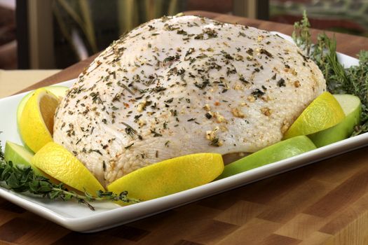 raw and juicy turkey breast seasoned with herbs, fresh and healthy food ready to go into the oven