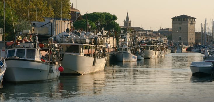 Fishermen's port in the rays of the setting sun. Cervia, Italy.