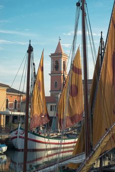 Sailing ships at the berth in the port of Cesenatico in Italy at sunset