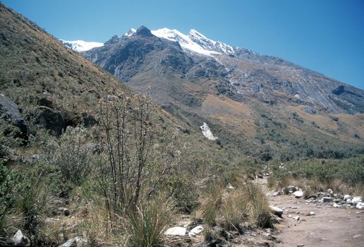 Beautiful valley in Peru with snow capped Andes Mountain peak rising above