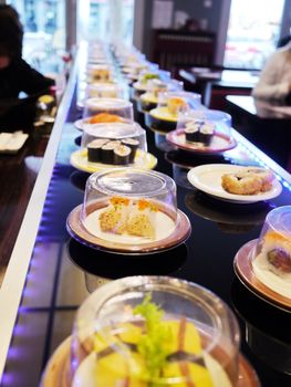 sushi belt with sushi dishes in a sushi bar