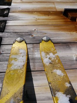 Image of skis leaning on a wooden wall