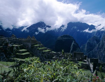 Beautiful historic ruins of Inca city Machu Picchu with Andes Mountains in background