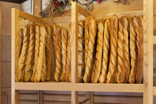 Bread baguettes standing up in a French bakery or boulangerie