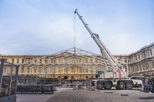 Big mobile construction crane erecting a temporary structure