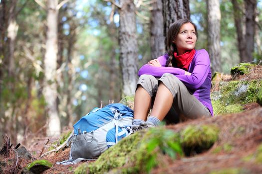 Person hiking - woman hiker sitting in forest resting during hike in beautiful forest. Orotava vally, Aguamansa, Tenerife, Canary Islands.