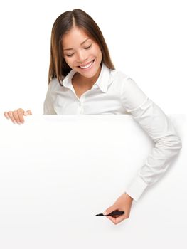 Woman writing on whiteboard sign from above. Woman holding pen smiling, drawing or writing with copy space for text. Beautiful mixed race Asian / Caucasian female businesswoman isolated on white background