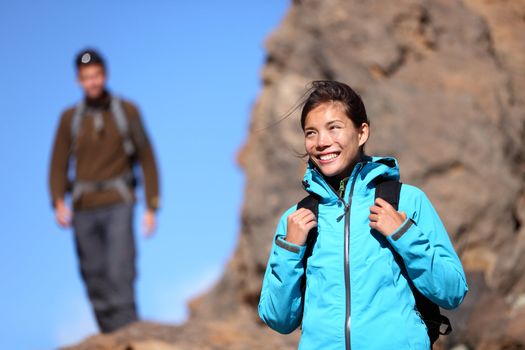 Hiking people. Hiker woman portrait outdoors in mountain scenery. Man in background.