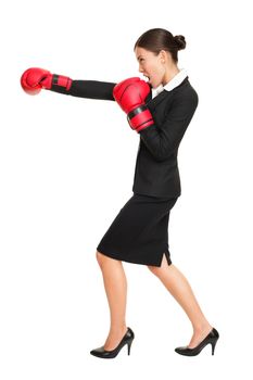 Business woman boxing - business competition concept with businesswoman punching and hitting standing in full length profile. Young Asian / Caucasian female professional isolated on white background.