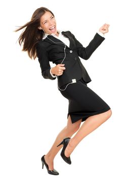 Woman listening to music on mp3 player, dancing playing air guitar. Funny happy portrait of business woman isolated on white background in full length.