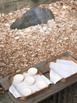 oriental atonement ceremony with small ceramic saucers and big boulder; you should buy the saucer and throw it to the big boulder. If saucer will be broken to the small pieces all evil you have done in past year will disappear.