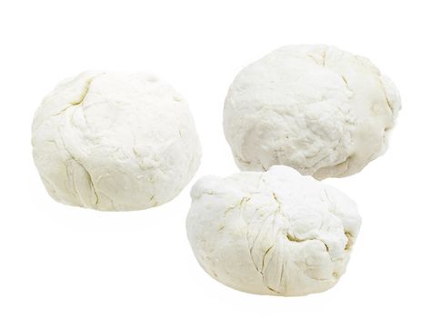 Three pieces of dough on a white