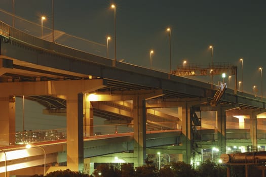 night illumination on the modern hanged up highway in Tokyo, Japan