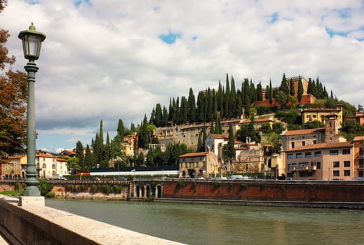 Panoramic view toward Castel San Pietro from the bank of the river Adige in Verona, Italy.