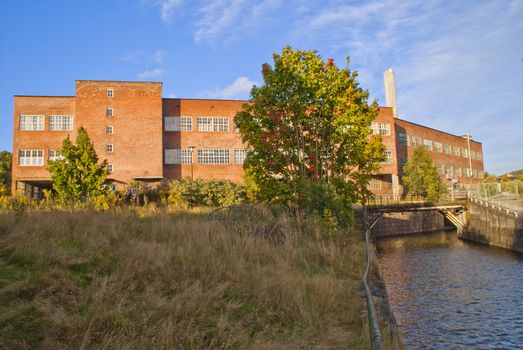 paper mill in Halden (Norway) which is the oldest wood processing plant in Norway, image is shot from the Tista river that flows past the factory. 