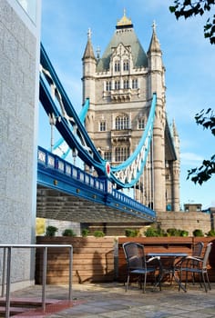 Table with chairs in a cafe terrace overloking the Tower Bridge in London