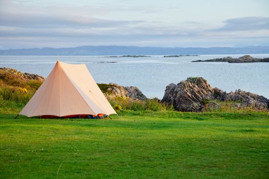 Camping tent on a shore in a morning light