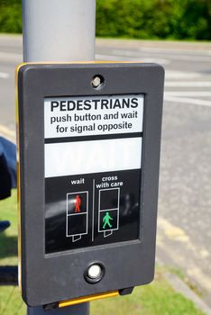 British pedestrian crossing button with wait sign