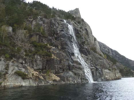 steep mountain with waterfall in norway, europe